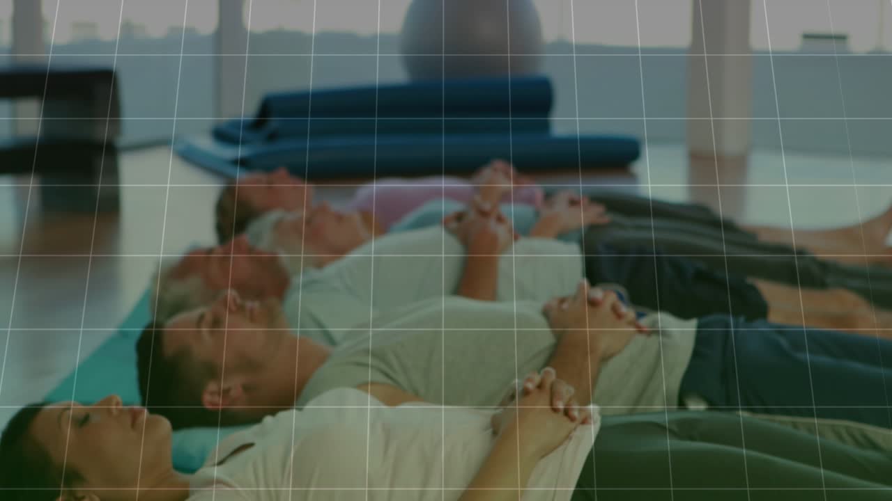 Trio lying on mats in fitness gym translucent grid appearing green charts animating tracking breath