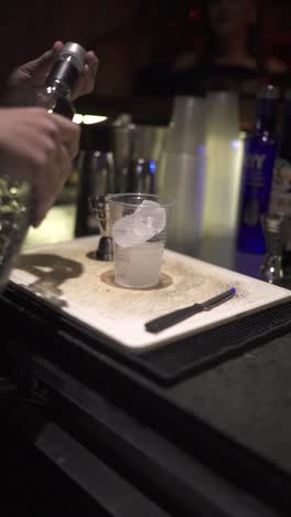 close-up of a single-use plastic cup, used to prepare cocktails at a party. argentina. vertical.