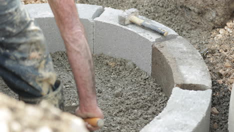 labourer uses a trowel to level the soil in road construction in leiria city, portugal