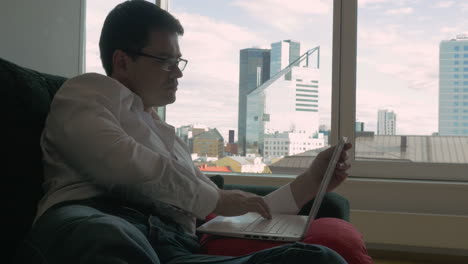 Businessman-Resting-on-the-Couch-with-Laptop