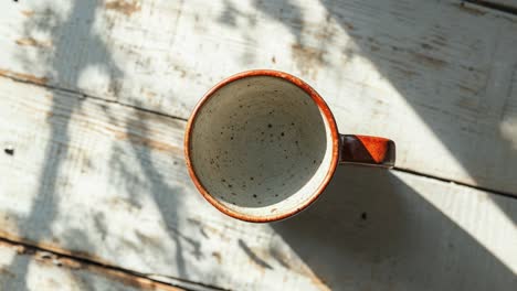 empty coffee mug on wooden table