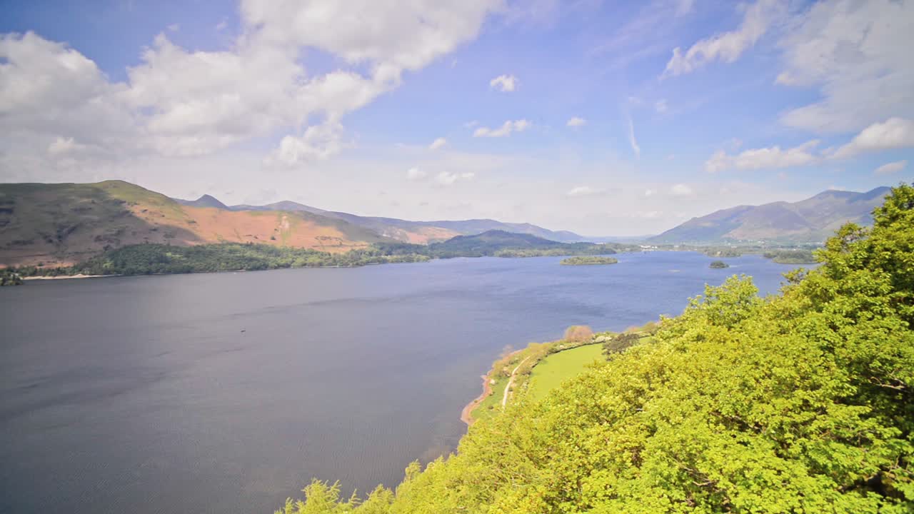 Beautiful Landscape At The Lake District Surrounded By The Green Mountains Under the Blue Sky During Summer In England.- wide shot