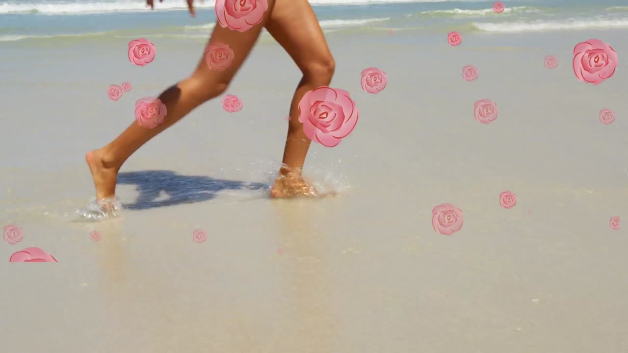 múltiples iconos de rosas rosas cayendo contra la sección baja de la mujer caminando por la playa