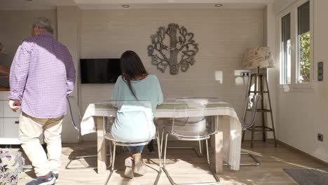gay couple preparing breakfast to eat with their daughter at home
