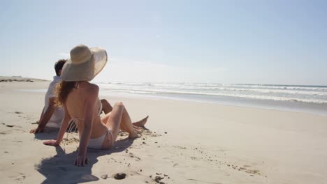 couple relaxing together at beach 4k