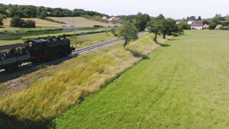 Followed-by-a-steam-train-up-close,-with-smoke,-tourist-train-to-discover-the-Lot-and-Martel,-France