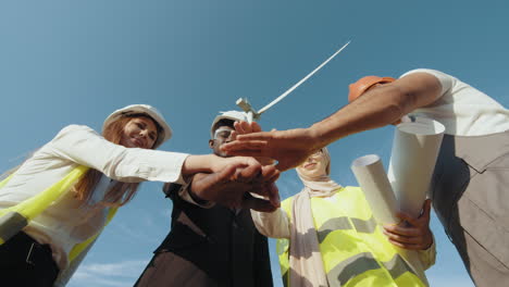 team celebrating wind turbine project