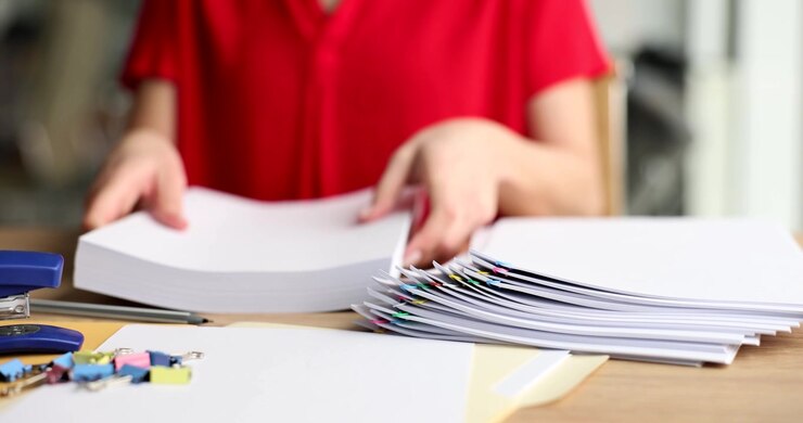 Organizing papers with care in a cozy workspace