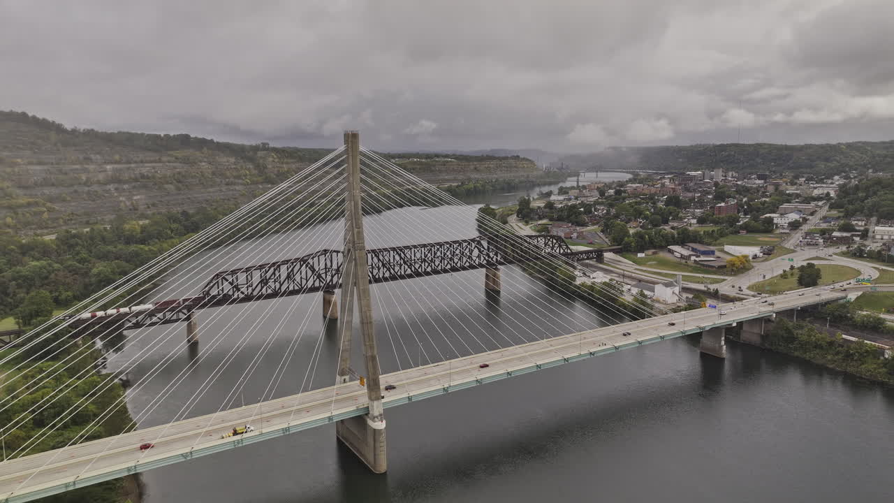 Steubenville Ohio Aerial v7 flyover the river towards town center capturing hillside views, vehicle traffic on Veterans memorial bridge and truss bridge - Shot with Mavic 3 Pro Cine - Sept 22nd 2023