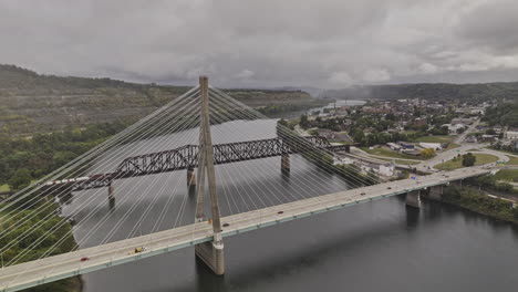 steubenville ohio aerial v7 flyover the river towards town center capturing hillside views, vehicle traffic on veterans memorial bridge and truss bridge - shot with mavic 3 pro cine - sept 22nd 2023