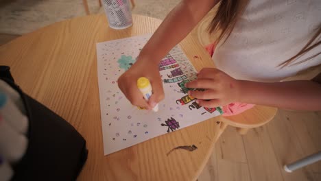 child drawing colorful artwork on paper