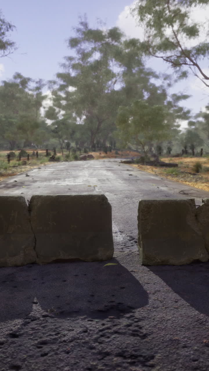 Blocked pathway through a quiet desert landscape under a bright sky