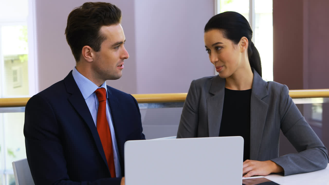 personas de negocios discutiendo por computadora portátil en el centro de conferencias