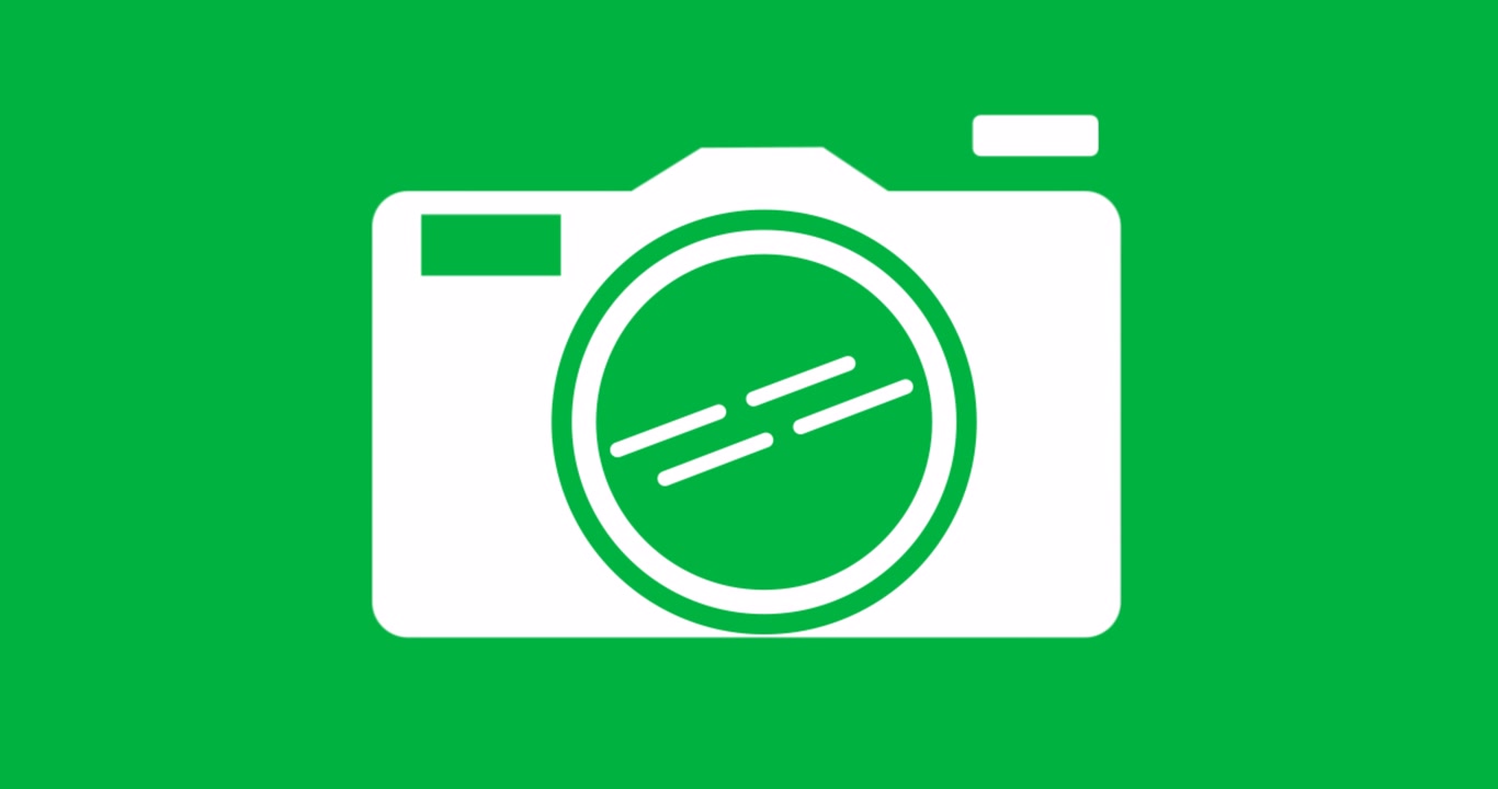 Graphic designers placing camera icon on transparent canvas, showing lens rings and viewfinder