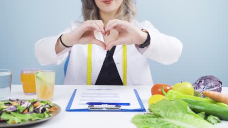 nutritionist dietitian doctor makes heart on camera. healthy lifestyle.