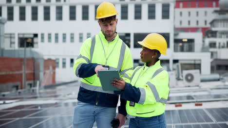 Construction Workers Inspecting Solar Panels on Rooftop