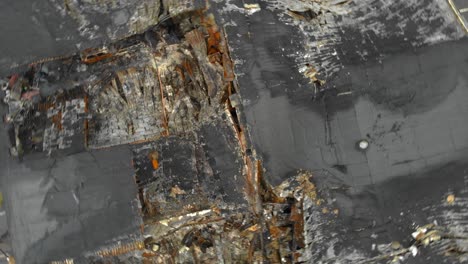 aerial view of roof surface severely damaged by fire, rotating shot