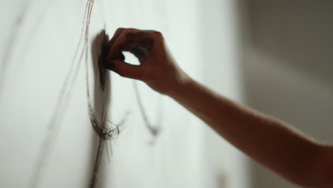 unrecognizable woman creating masterpiece indoors. girl hand hatching on canvas.