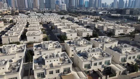 aerial establishing shot of walking man on rooftop enjoying skyline view of dubai at sunny day