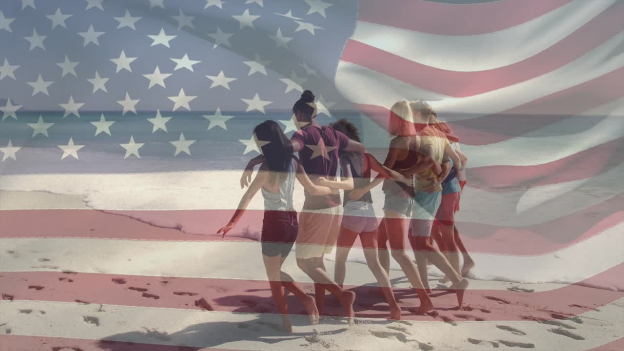 Friends linking arms starting walk on sand, flag overlay rippling over group for marketing
