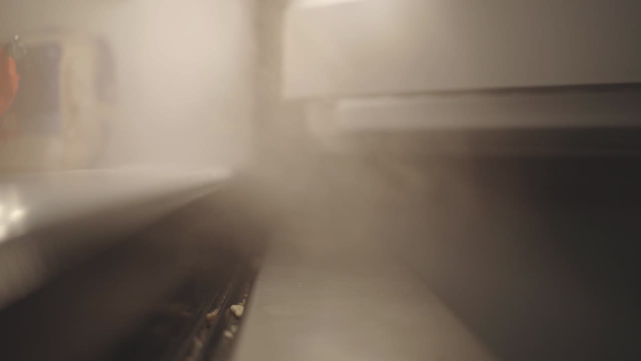 Steam From An Open Freezer In The Dark Kitchen - closeup shot