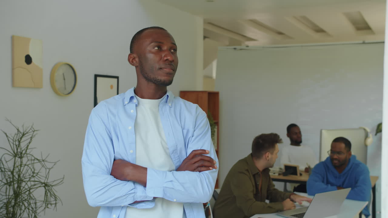 Confident Black CEO Posing at Modern Startup Office