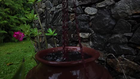 raindrop rain water collecting in clay pot up-close slow motion rainfall