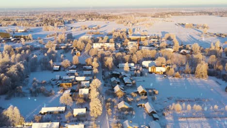 iconic countryside township covered in snow in sunny winter day, aerial view