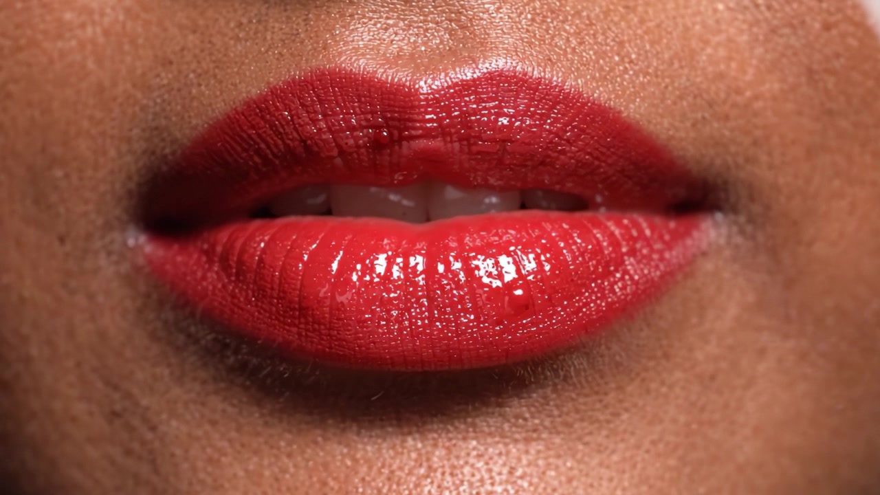 Close-Up of Glossy Red Lips Showcasing Vibrant Color and Smooth Texture in a Beauty Video Focused on Lip Makeup Techniques and Aesthetics
