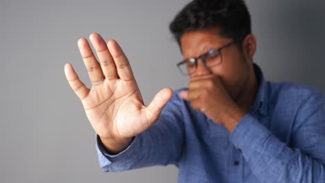 man showing stop sign with hand