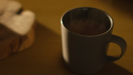 close up of steaming cup of hot chocolate drink on table