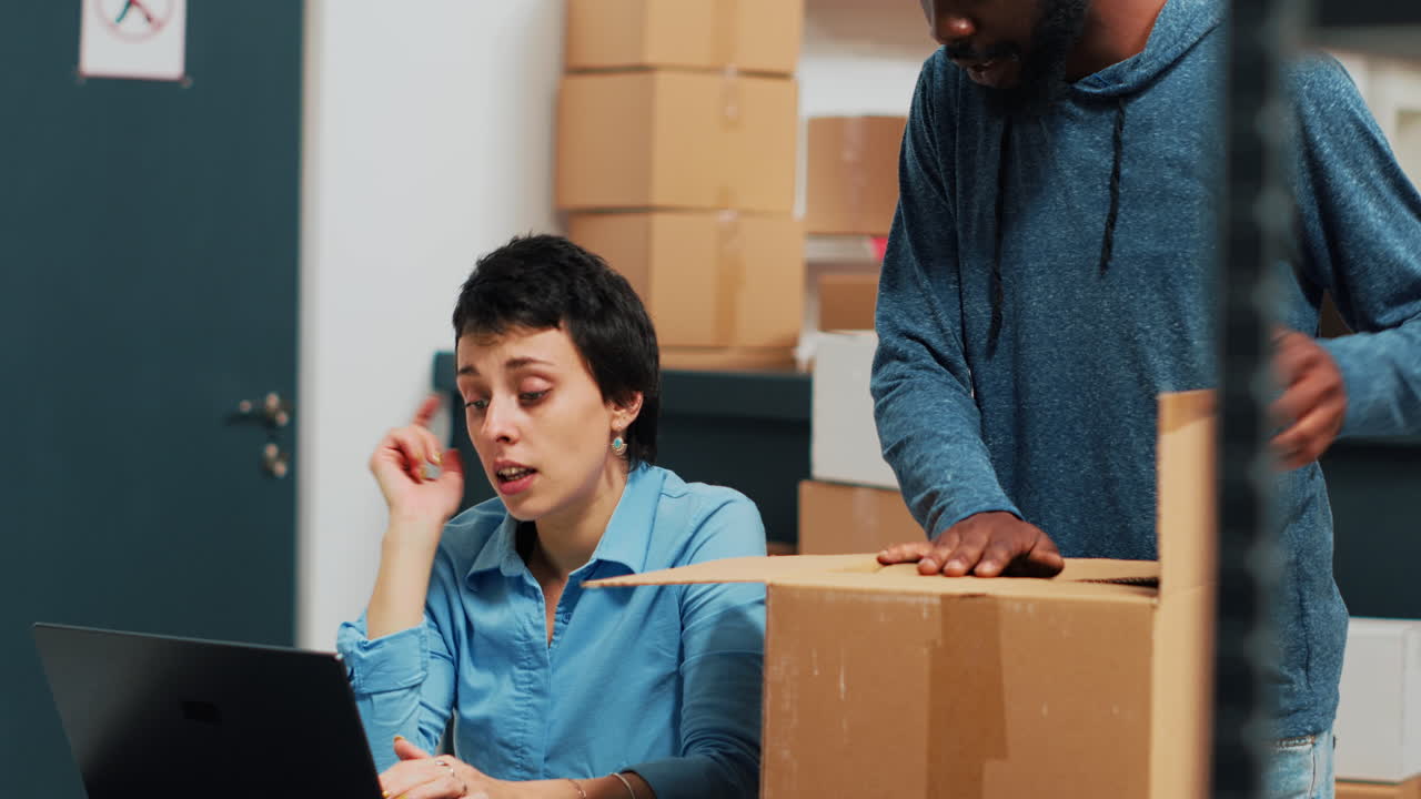 Warehouse workers packaging and shipping products