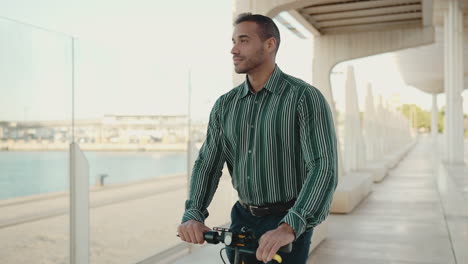 young man riding a scooter outdoors.