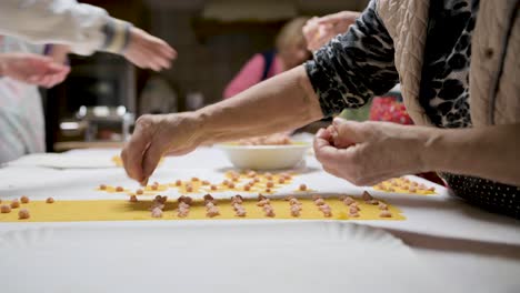 crop women cooking traditional tortellini in kitchen