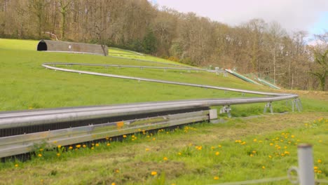 detail of alpine coaster on a mountain in a large green area