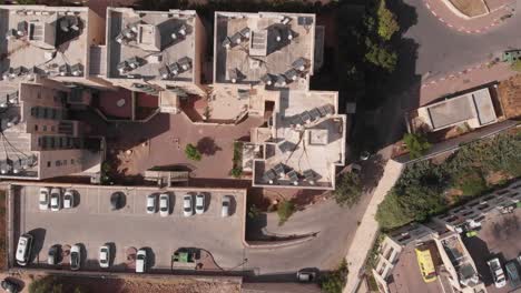 aerial view of residential complex with parking and solar panels