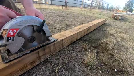 slow motion - cutting a 4x4 wooden post with a circular saw