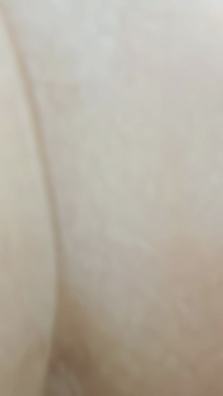 Vertical video: Camera showing smooth surface filling frame in closeup to show subtle light shifts