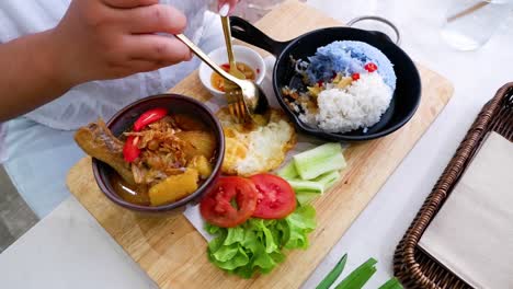 savoring traditional thai dish with chicken and rice