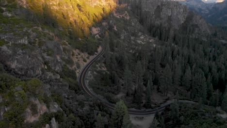 Aerial-pan-up-of-a-windy-road-up-a-high-sierra-pass-in-California-at-sunset