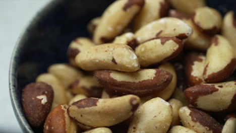 brazil nuts rotating in blue bowl