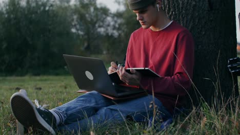 young man studying outdoors