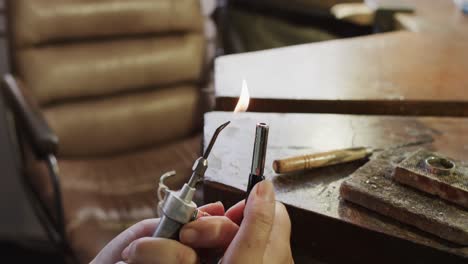 Caucasian-female-worker-using-blowtorch-in-workshop-in-slow-motion