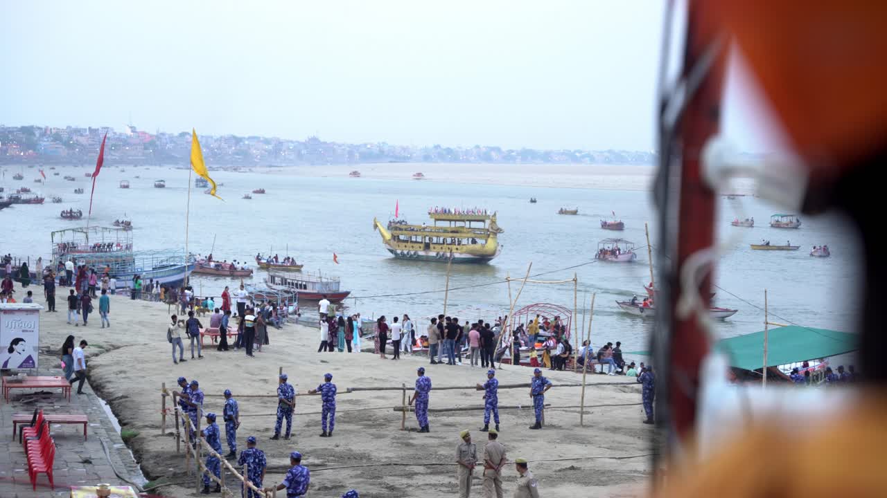 Central Reserve Police Force Indian government employees at Assi ghat during political rally campaign, Assi ghat tourists cruise and boats sailing on Ganga river