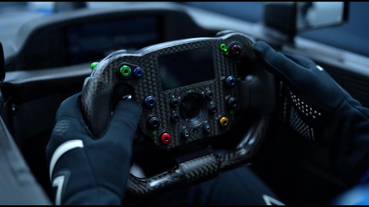 Race Car Driver Holding Carbon Fiber Steering Wheel