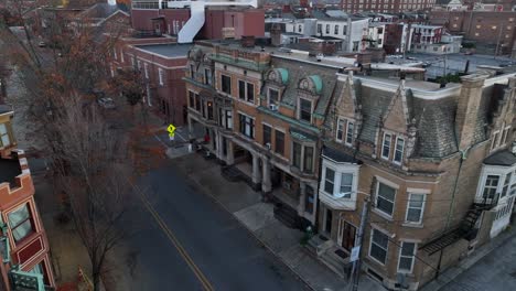 victorian homes in american city at dusk in autumn