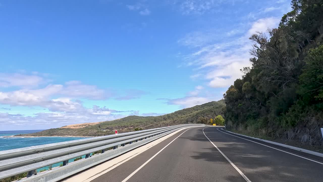A 44-second video capturing a drive along the Great Ocean Road, showcasing coastal views and lush greenery under clear skies