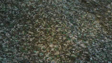 mountain of recycled glass fragments at a factory that recycles glass from cans, bottles and windows