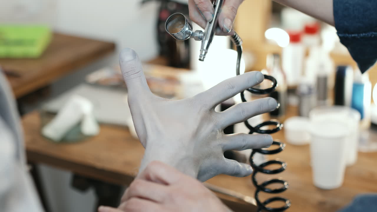 SFX Makeup Artist Applying Body Paint on Hand