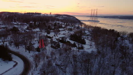 aerial - flying over houses on the coast of the st-lawrence river at sunset-1